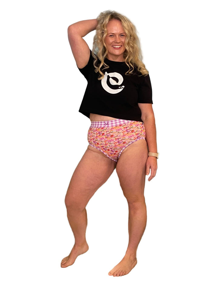 Blond woman wearing discharge friendly underwear and a black tshirt with a spiral logo.