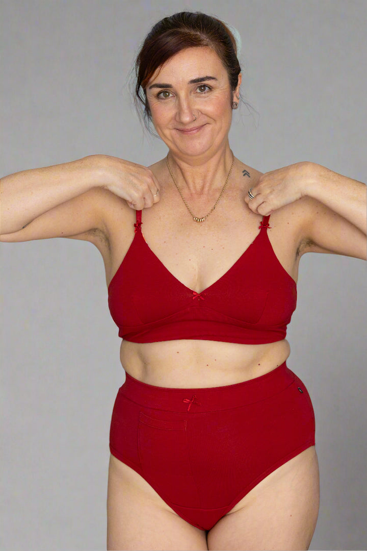 woman wearing matching red bralette and discharge underwear