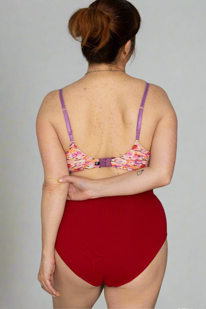 Woman with brown red hair in floral bralette and discharge underwear