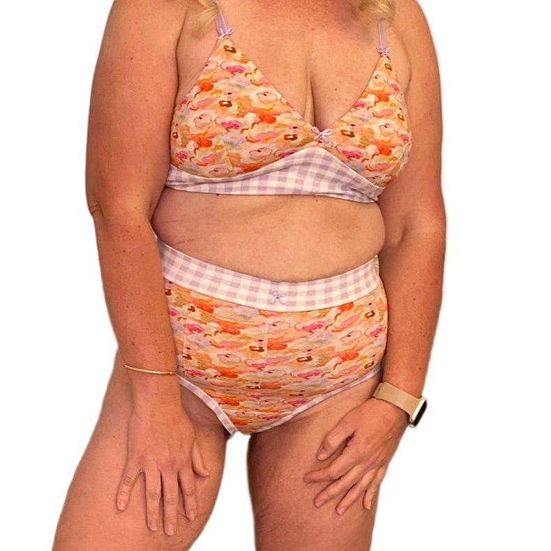 A woman wearing high-waisted discharge underwear with floral and gingham.