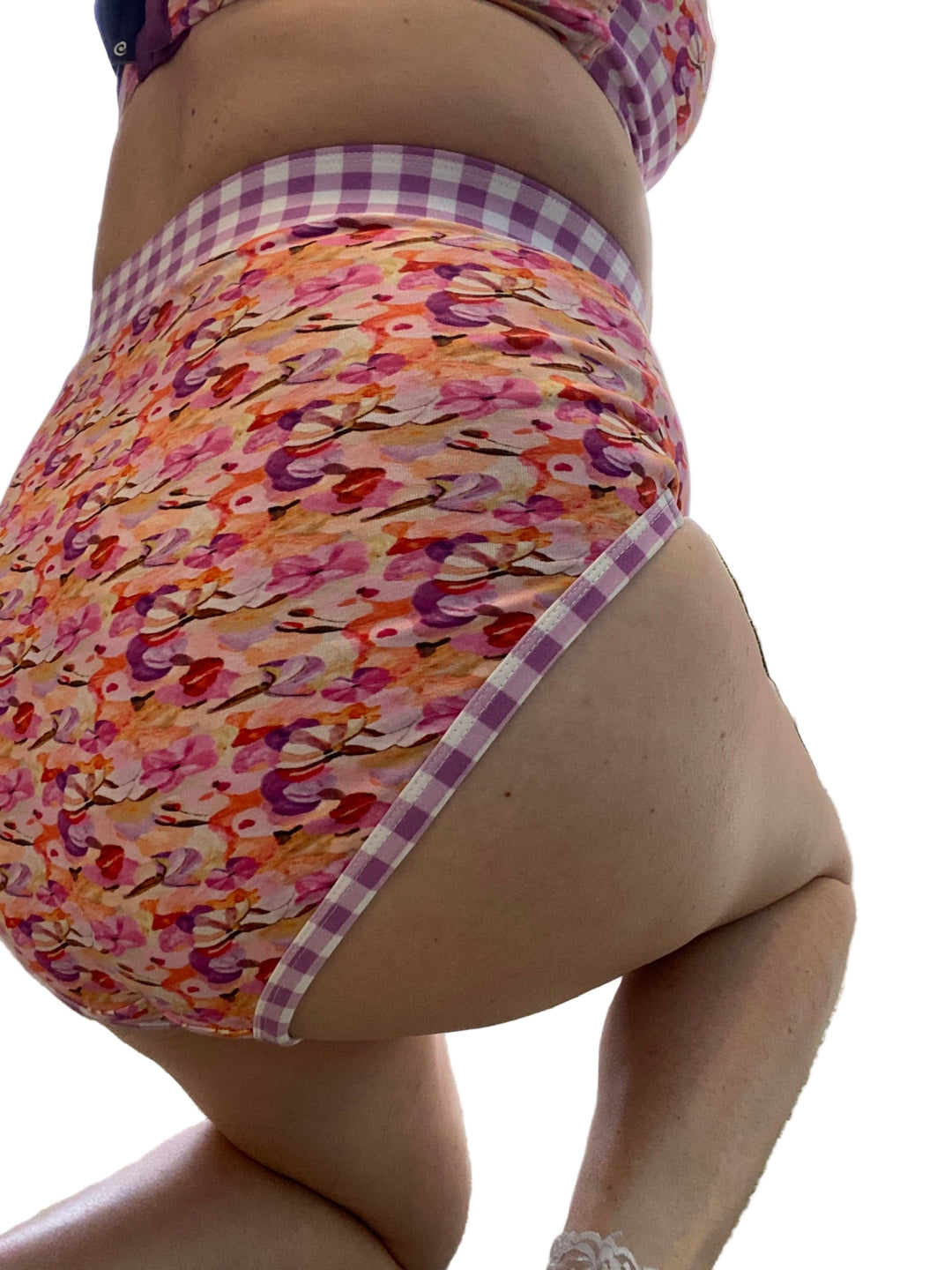 Woman wearing floral discharge undies with gingham waistband